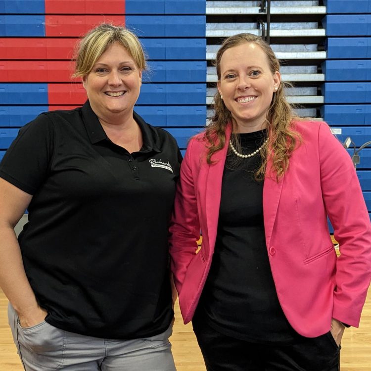 Amy and Danelle standing side by side at a speaking event