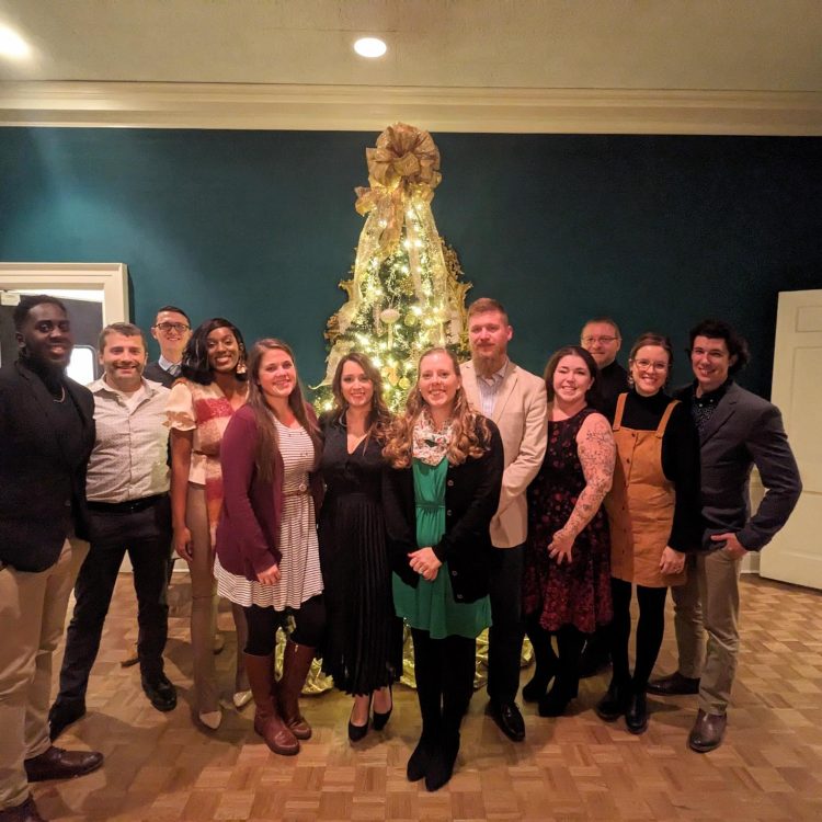 RPS team and their spouses at a christmas party, gathered in front of a tree, december 2022